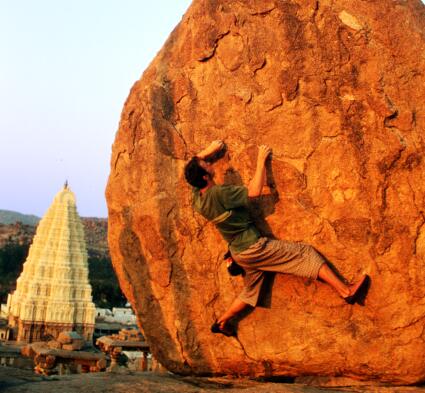 The author, a crimpy V4 and a Hampi sunset, Hemakuta Hill